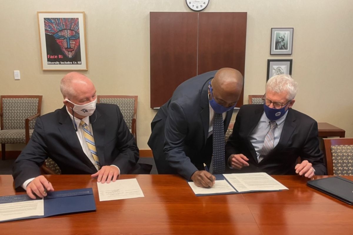 Dr. Terry Brown signs the Innovative Transfer Agreement